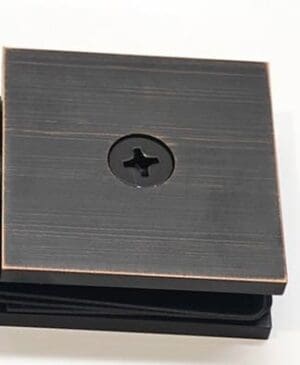 Black square hinge with central cross design.