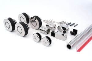 A collection of precision metal components arranged on a white surface.