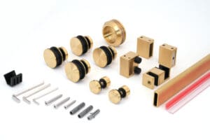 Assorted brass and black hardware components with screws on a white background.