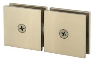 Close-up of two metal plates joined by a central hinge with screws.