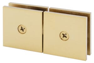 Close-up of two gold-colored metal pieces with screws.