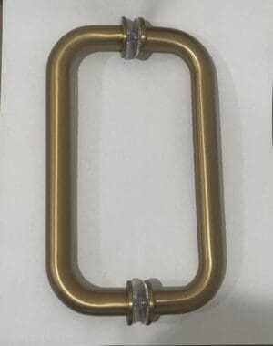 Gold rectangular door handle on paper.