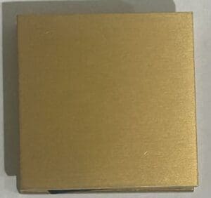 Gold square box on a white surface.